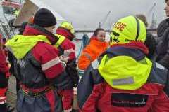 służby ratownicze na statku, widać kobietę uśmiechającą się