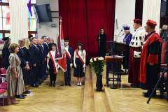 Uroczystość absolutoryjna w auli – poczet sztandarowy, władze uczelni w togach oraz przemówienie przy mównicy