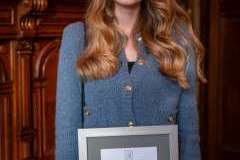 kobieta trzymająca przed sobą w rękach dyplom