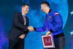 dwóch mężczyzn na scenie, podają sobie rękę